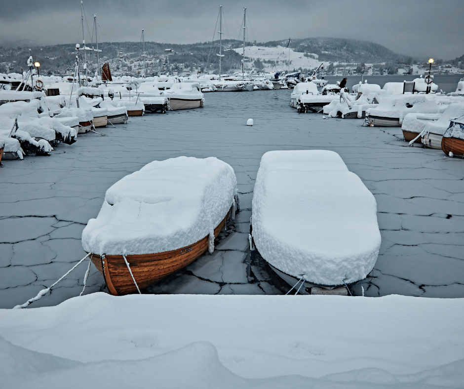 Boote mit Schnee überdeckt auf Eis