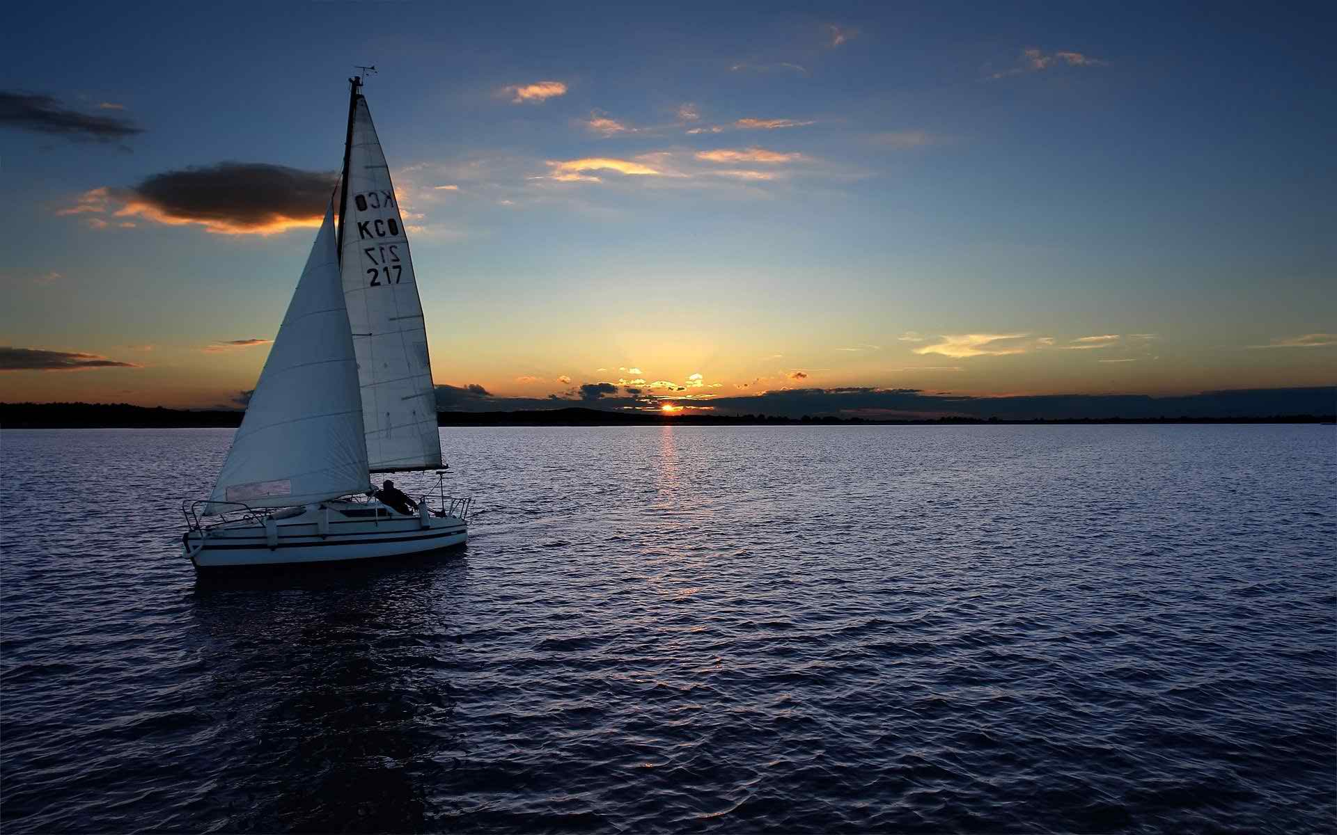 Sailboat at sea during sunset in Barcelona