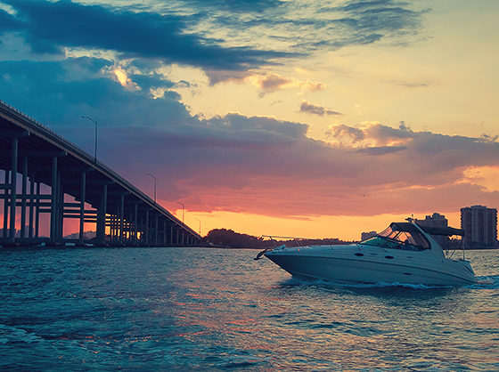 Boat passing under a bridge at sunset, Miami Nautal