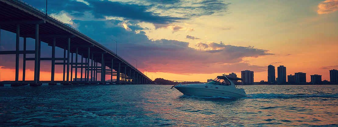 Boat passing under a bridge at sunset, Miami Nautal