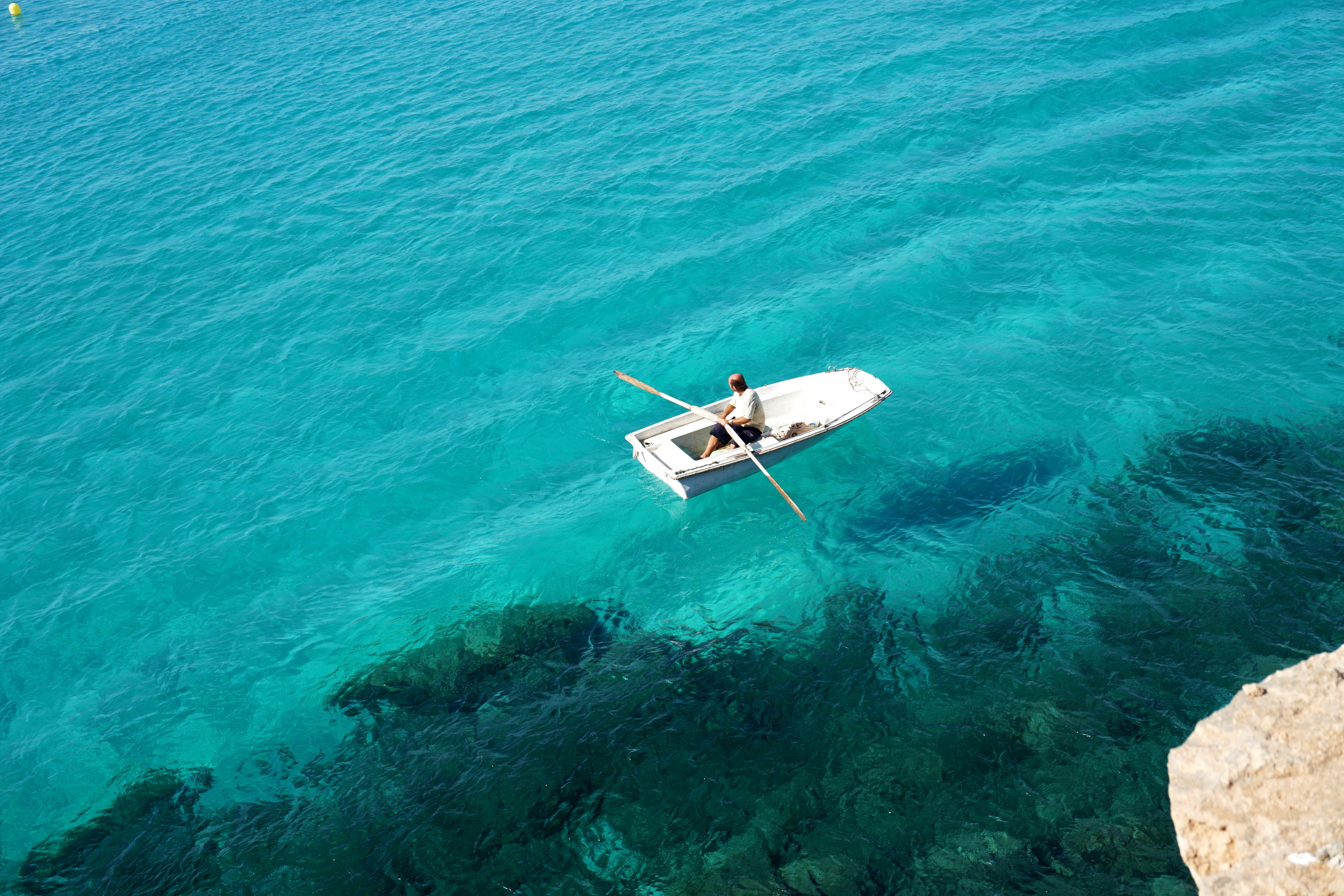 Man in little boat on the sea, rent a boat in Spain