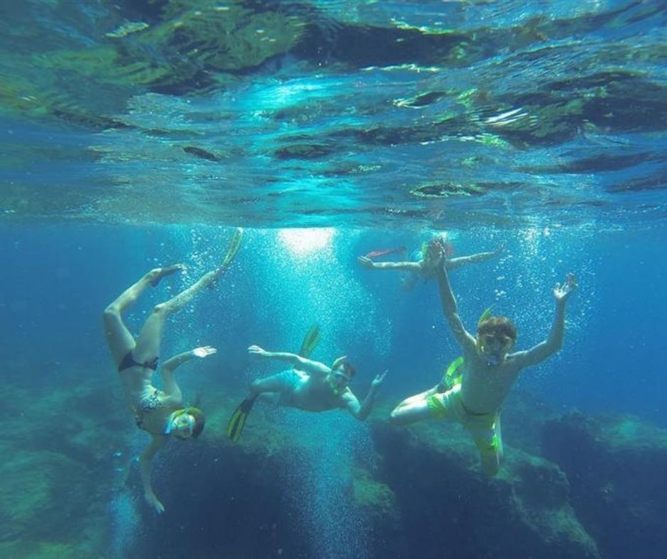 Family travelling together, snorkelling