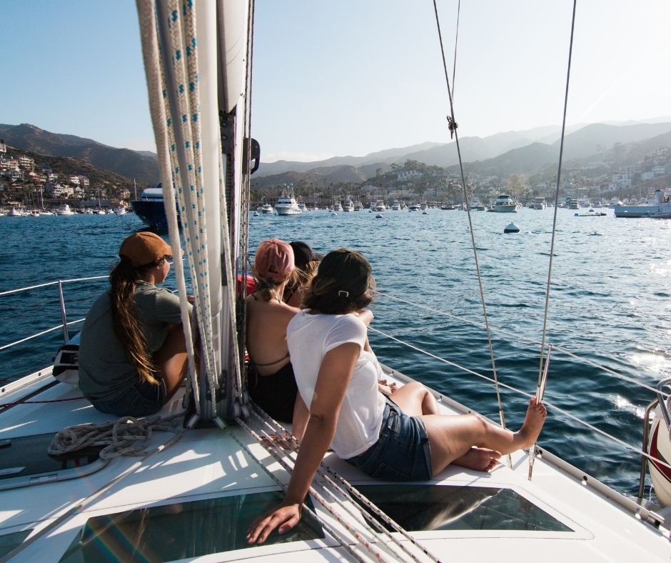friends sitting on the yacht in Marbella and sailing to the bay