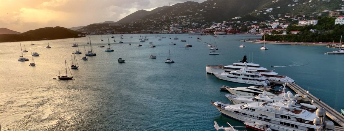 many boats and yachts sailing thorugh the US virgin islands on a sunset