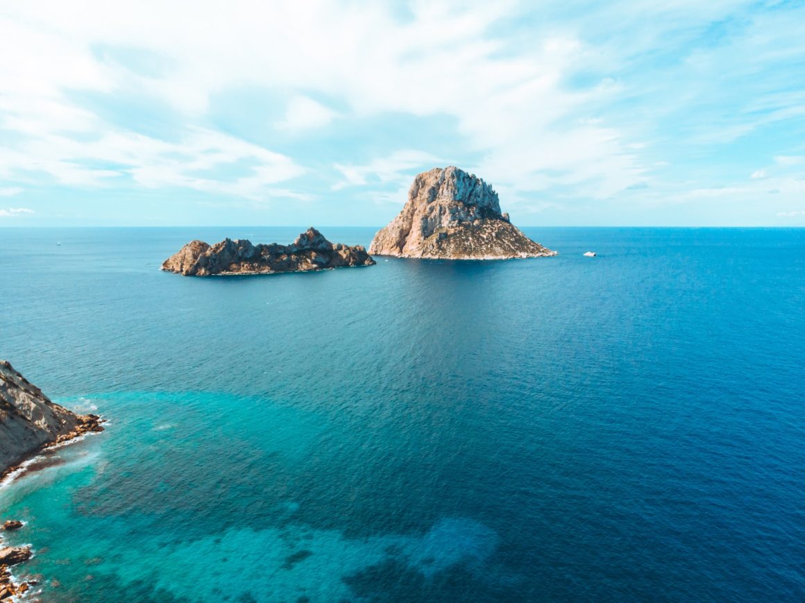 Blue waters and rock formations in Es Vedra in Ibiza, Spain as a boating destination