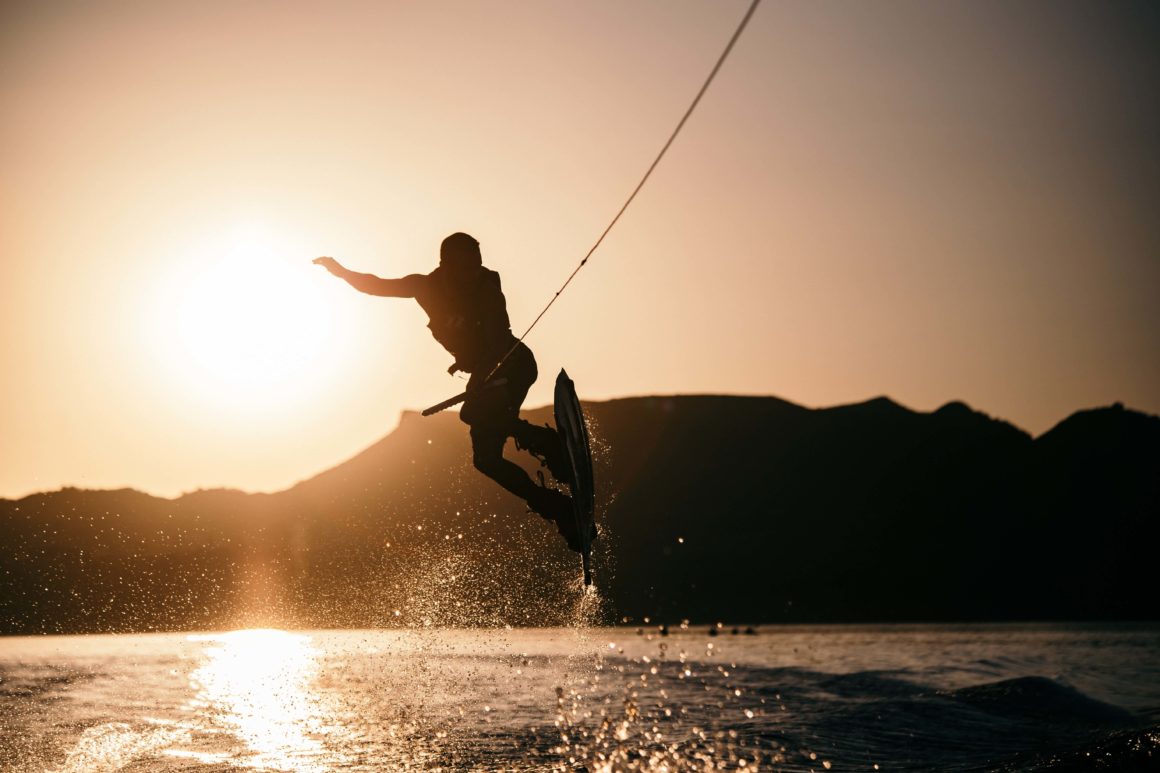 Silhouette of wakeboarder jumping in the sunset