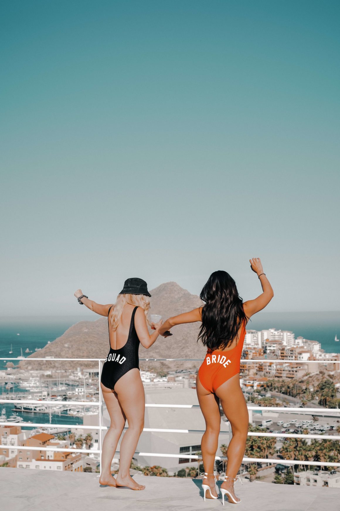 Bride and bridesmaid celebrating a bachelorette party at the beach