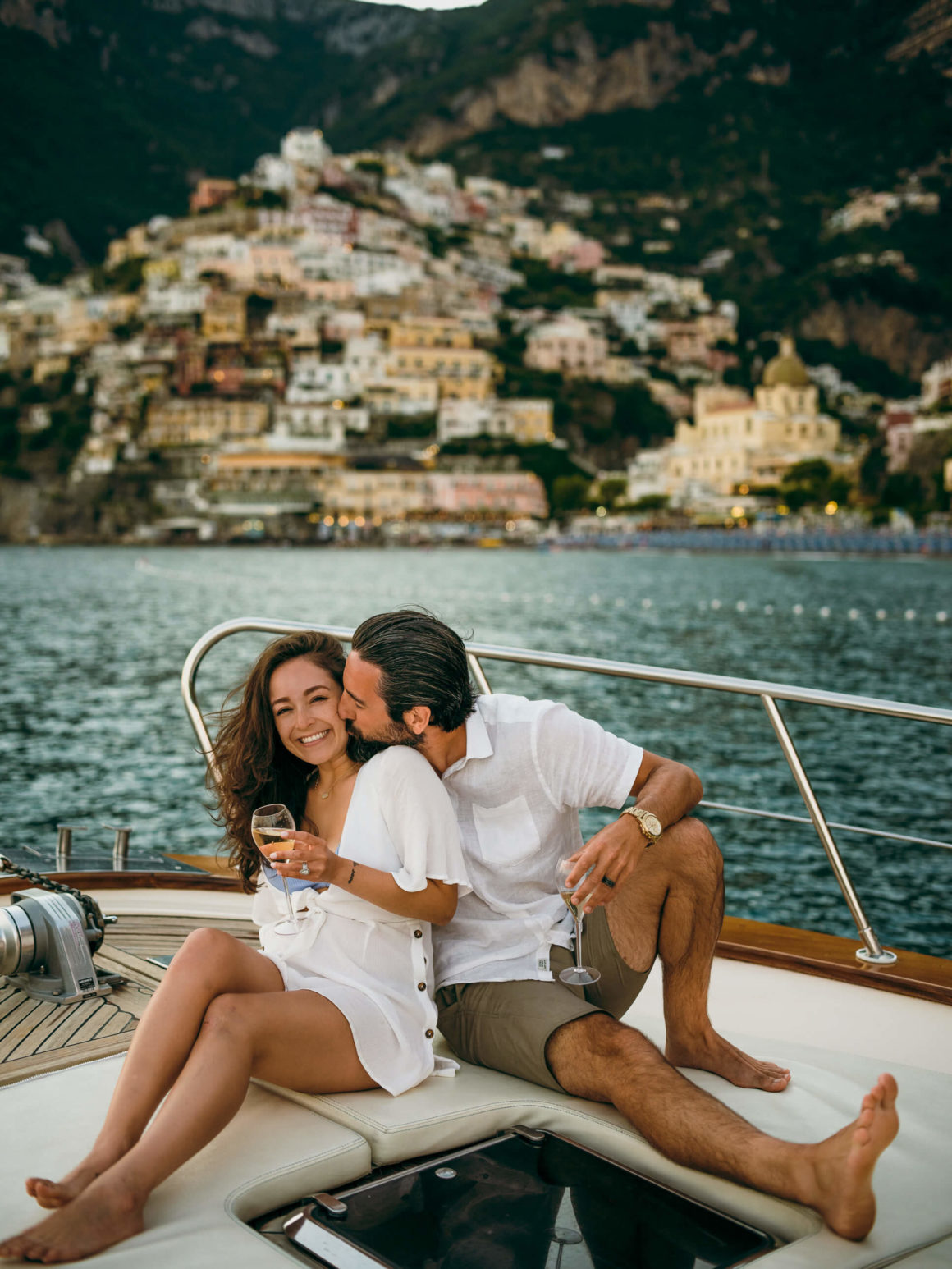 A couple on their honeymoon on a boat off the Amalfi Coast