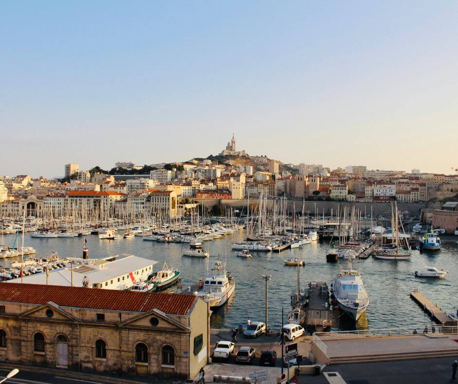 View of the sun setting in a port in Marseille