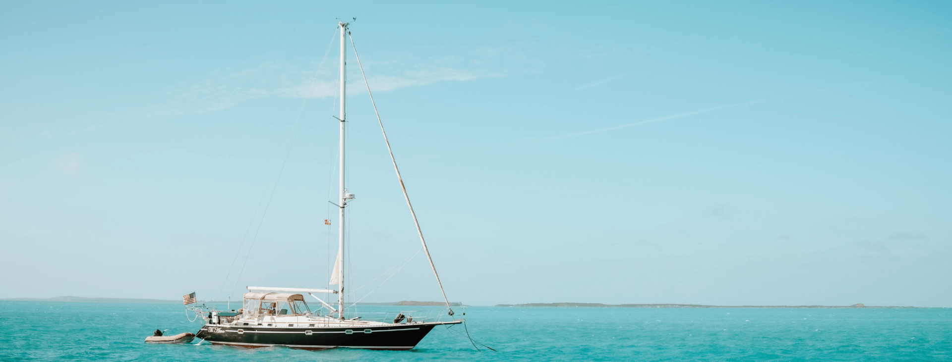 Sailboat anchored in turquoise sea